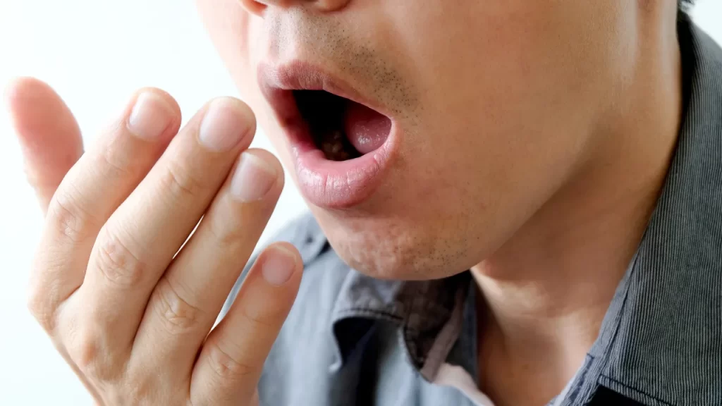 man testing bad breath